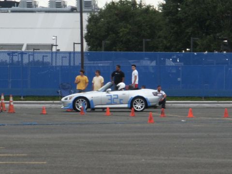 2001 Mercury Grand Marquis - A silver convertible sports car with blue accents and the number 32 is visible at an event with spectators.
