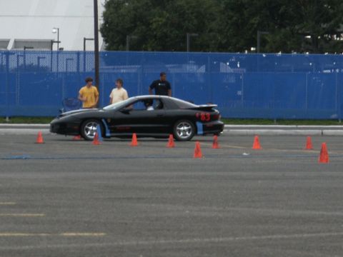 2001 Mercury Grand Marquis - Black Pontiac Firebird with number 83 on the side is set up for an autocross event.