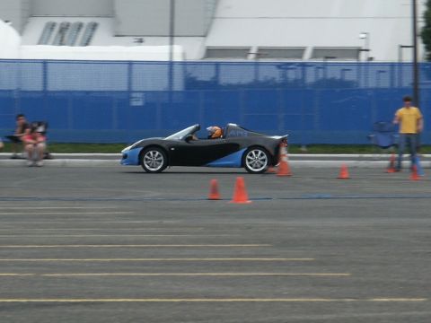 2001 Mercury Grand Marquis - Sports car with blue accents navigates a course marked by orange cones.