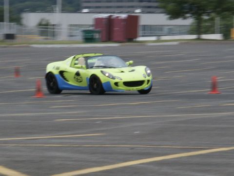 2001 Mercury Grand Marquis - A lime green and blue sports car navigates a course marked by orange cones.