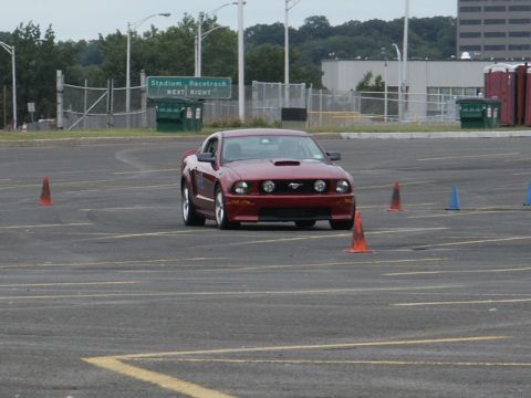 2001 Mercury Grand Marquis - A red 2005 Ford Mustang GT navigates a course marked by traffic cones.
