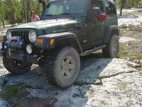 1986 Ford F-150 - Jeep Wrangler Rubicon navigating rocky terrain off-road.