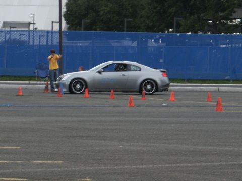 2001 Mercury Grand Marquis - A silver coupe is seen on a road course with orange cones marking the path.