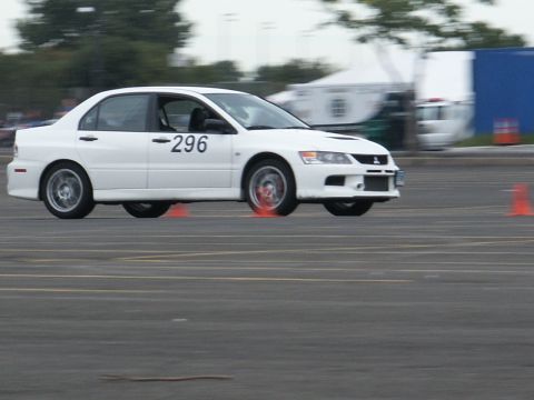 2001 Mercury Grand Marquis - A white sedan with racing number 296 navigates a course marked by orange cones.
