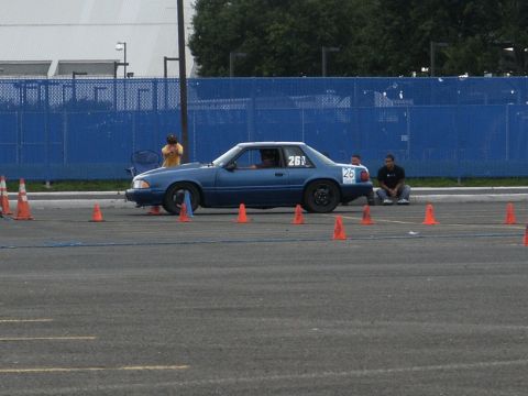 2001 Mercury Grand Marquis - A blue coupe with racing numbers is seen on an asphalt course, possibly during a timed event.
