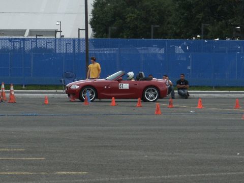 2001 Mercury Grand Marquis - A red convertible is set up for a driving event with cones marking a course.
