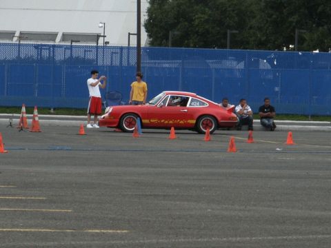 2001 Mercury Grand Marquis - A red Porsche 911 Carrera is set up for an autocross event with orange cones marking the course.