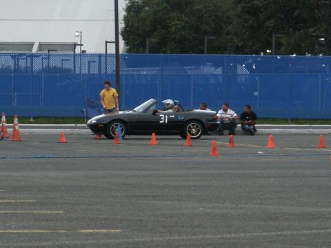 2001 Mercury Grand Marquis - A black convertible sports car with the number 31 on its side is parked on an asphalt lot, surrounded by orange cones.