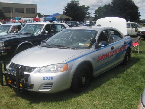 1991 Ford LTD Crown Victoria - silver sedan marked EMERGENCY SERVICE UNIT 2550 with red-and-blue striping and a front push bar at an outdoor police show.