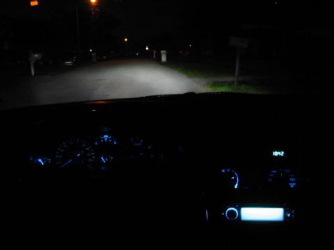 1995 Ford Thunderbird - View from driver's seat at night, showing illuminated dashboard gauges and digital clock.