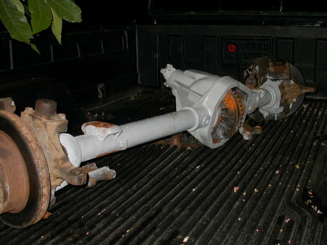 Painted truck axle and driveshaft assembly in a pickup bed