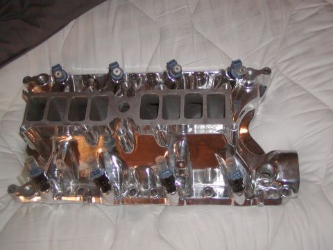 1991 Ford Bronco - Chrome intake manifold with fuel injectors, likely for a V8 engine.