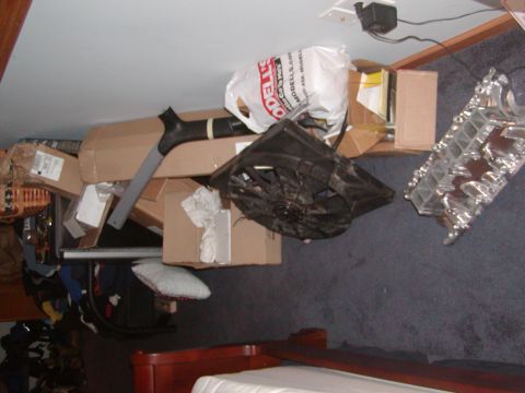1991 Ford Bronco - A cluttered storage area filled with boxes and various automotive parts.