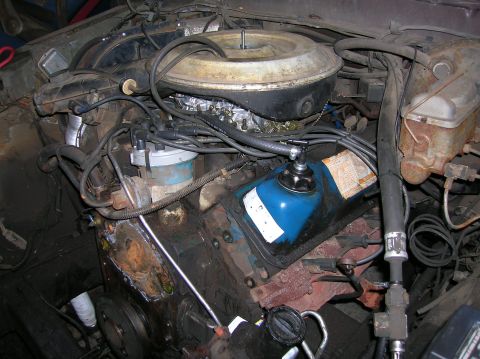 1978 Ford F-250 - The engine bay of a 1978 Ford F-250 shows the carburetor, distributor, and other engine components.