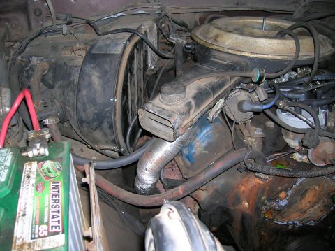1978 Ford F-250 - Close-up view of a V8 engine bay, showing the carburetor, distributor, and battery.