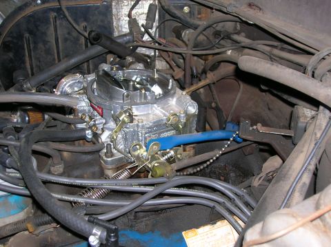 1978 Ford F-250 - Close-up view of a vehicle's engine bay, focusing on the carburetor and associated components.