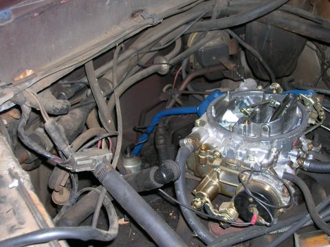 1978 Ford F-250 - Close-up view of a carburetor and engine bay components, with numerous hoses and wires visible.