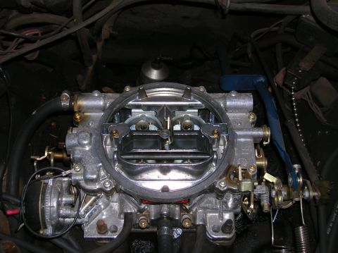 1978 Ford F-250 - This image shows a detailed view of a vehicle's carburetor, highlighting its complex internal components and external connections.