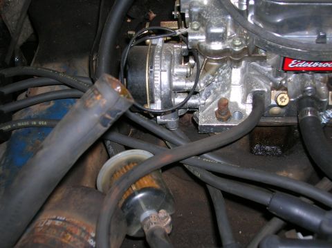 1978 Ford F-250 - A close-up view of an engine's carburetor and fuel filter assembly, showing various hoses and mechanical components.