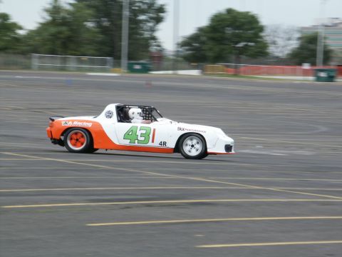 2001 Mercury Grand Marquis - Race car with number 43 on track, driver visible inside the cockpit.