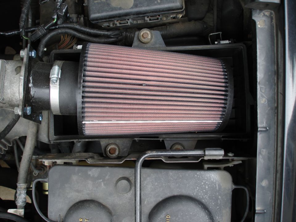 Aftermarket engine air intake filter installed in a vehicle's engine bay