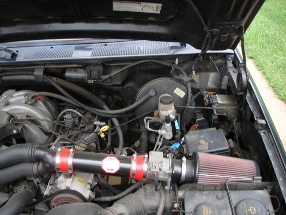 Engine bay with aftermarket air intake and red filter