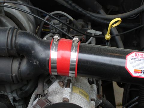 1994 Ford Bronco - Engine air intake hose with K&N sticker and red silicone coupler.