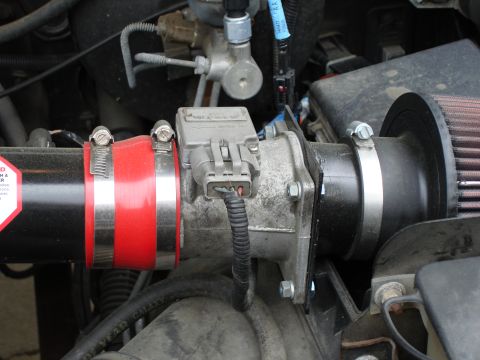 1994 Ford Bronco - The engine's air intake system, including a mass airflow sensor and an aftermarket air filter, is shown in detail.