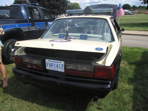 1991 Ford LTD Crown Victoria - Rear view of a cream-over-black Ford Mustang Florida Highway Patrol car with roof lightbar, Ford oval and Florida 'FHP1417' trooper plate,…