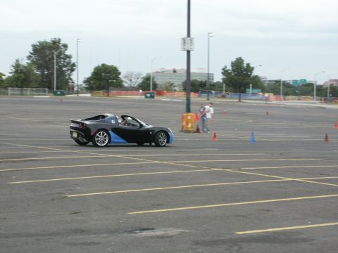 2001 Mercury Grand Marquis - Sports car navigates a course marked by cones in an open paved area.