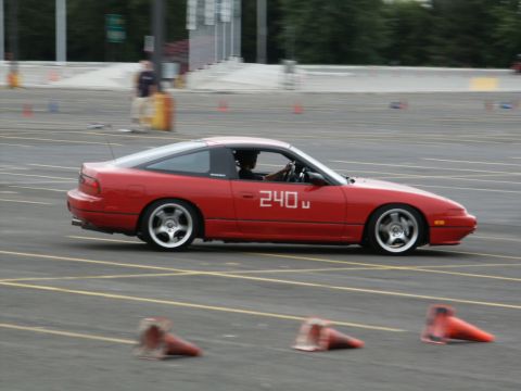 2001 Mercury Grand Marquis - Red Nissan 240SX coupe seen on a track during an event.