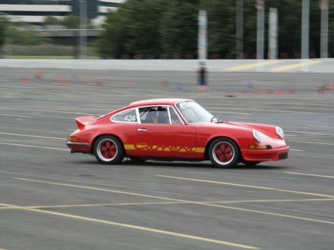 2001 Mercury Grand Marquis - A red Porsche 911 Carrera is seen on a race track with orange cones in the background.