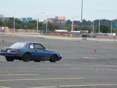2001 Mercury Grand Marquis - A blue coupe with the number 26 on its door navigates a course marked by orange cones.