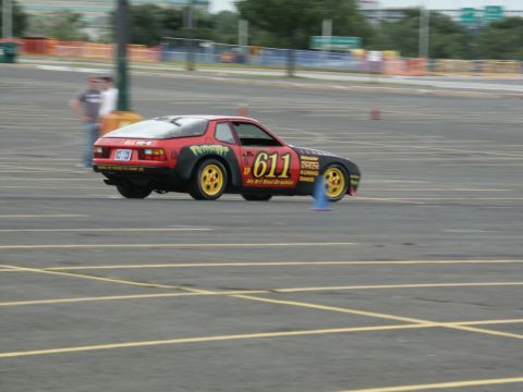2001 Mercury Grand Marquis - Porsche 944 race car with number 611 and various decals navigates a track.