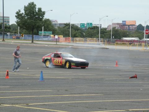 2001 Mercury Grand Marquis - A Porsche 944 is seen drifting in a parking lot with a person running nearby.