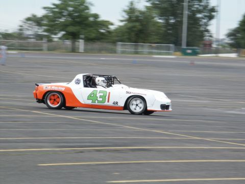 2001 Mercury Grand Marquis - A race car with the number 431 is seen on a paved track with trees in the background.