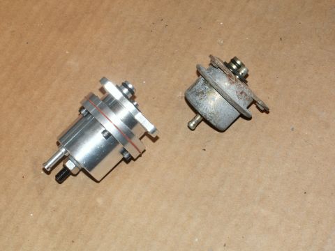 1990 Ford Mustang - Comparison of a new aluminum fuel pressure regulator next to an older, corroded unit.