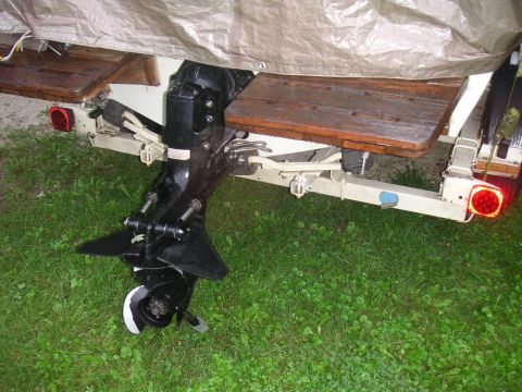 1979 Four Winns 170 Horizon - The rear of a boat on a trailer, showing the outboard motor and trailer hitch.