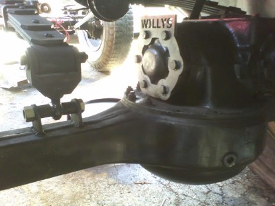 1979 Ford F-150 - Close-up of a vehicle's axle assembly, a Willys badge and suspension parts.