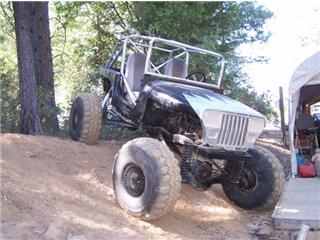 1986 Ford Bronco - Custom off-road buggy with a modified front grille and large tires is seen on a dirt hill.