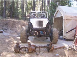 1986 Ford Bronco - A heavily modified Jeep sits outside with its front axle removed, ready for off-road adventures.