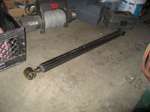 1990 Ford F-250 - A metal rod with a joint is on the floor near a winch and a crate.