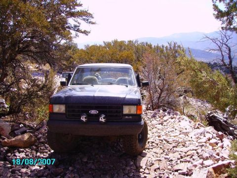 1990 Ford Bronco - Front view of a 1987-1991 Ford F-Series truck driving off-road.