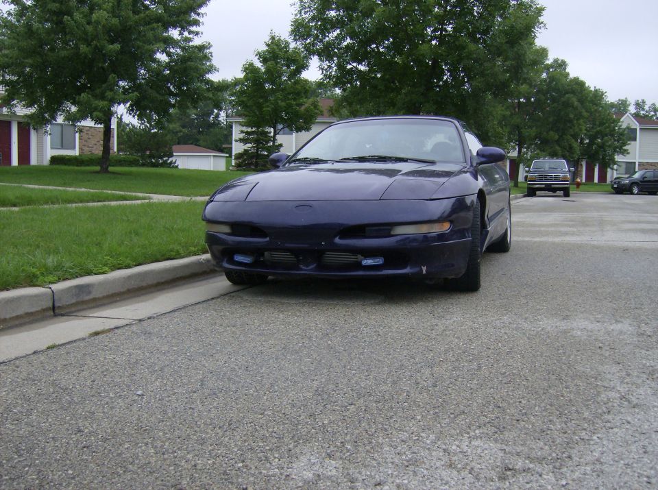 Dark purple Ford Probe front view with blue driving lights and intercooler in bumper