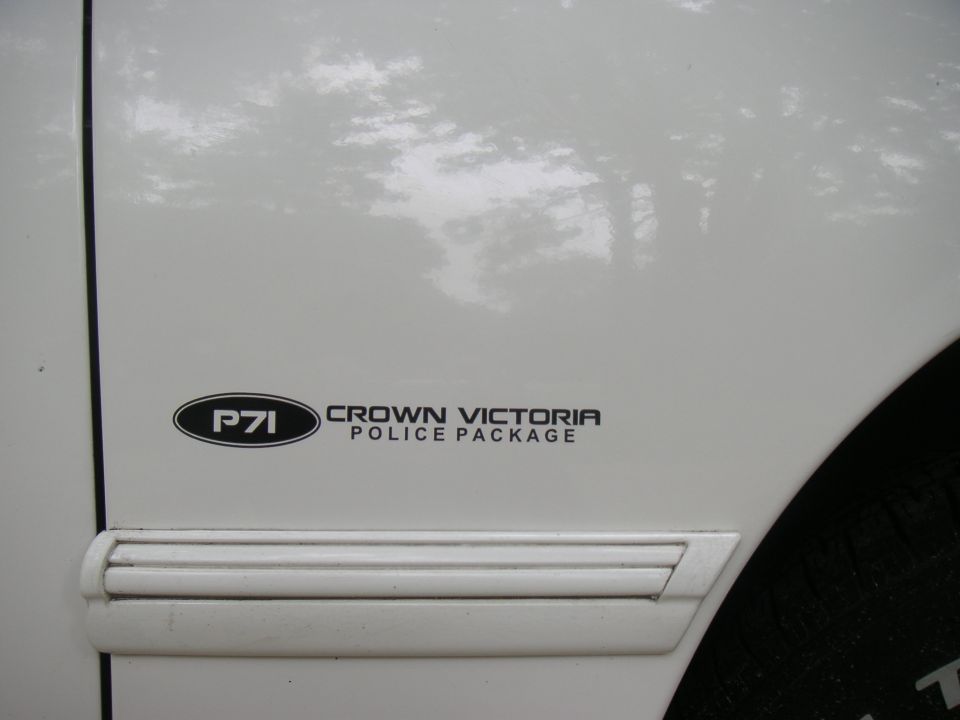 White car door with "P71 Crown Victoria Police Package" sticker