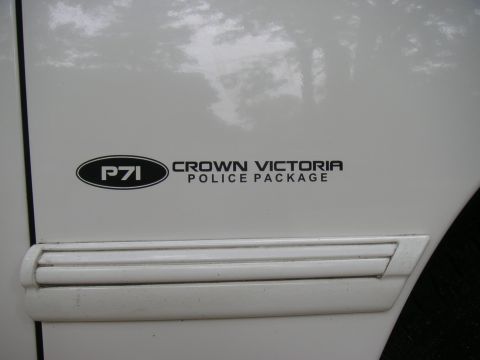 1997 Ford Crown Victoria - Close-up of the P71 Police Package badge on a white Crown Victoria.