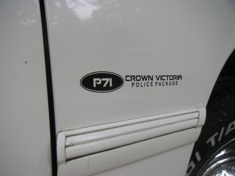 1997 Ford Crown Victoria - Close-up of a 'P71 Crown Victoria Police Package' decal on the side of a white vehicle.