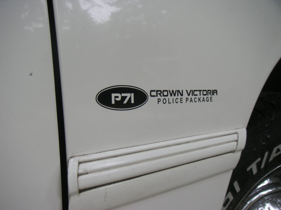 Side view of a white vehicle door with a P71 Crown Victoria Police Package decal