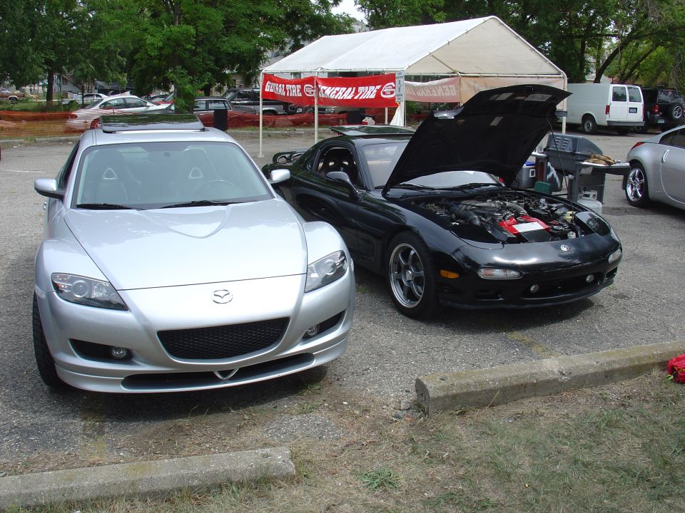 Black Mazda RX-7 with hood open, front view. Seen year 1992