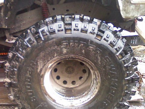 1991 Chevrolet Suburban - A close-up view of a heavily treaded off-road tire, likely used for terrain.